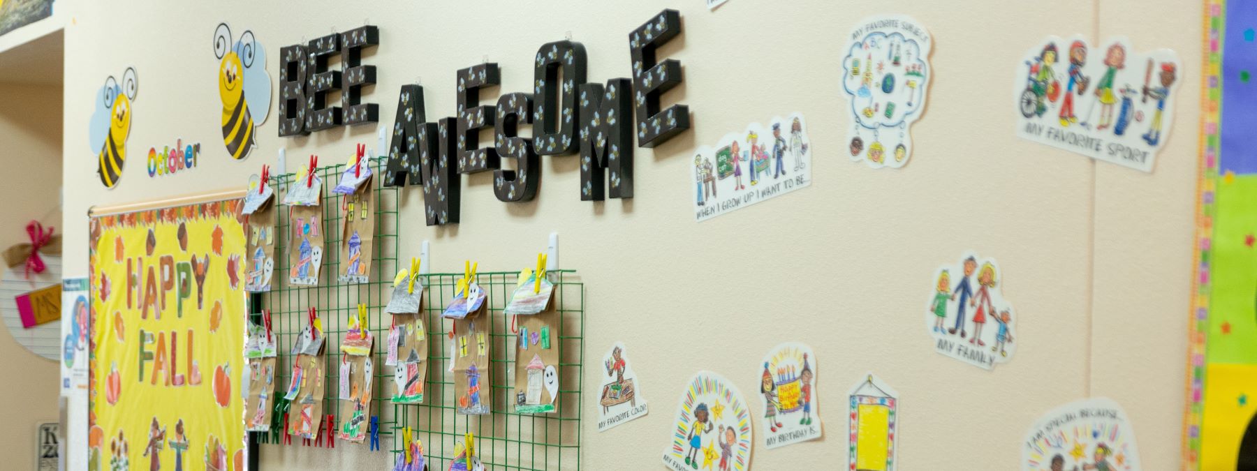 bulletin board with students work and bee awesome sign