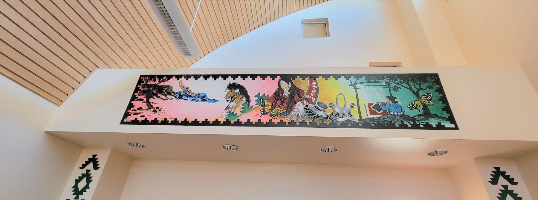 A colorful mural depicting a horse and people performing various activities.