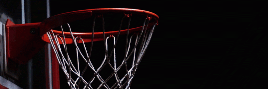 Basketball into goal with warrior logo